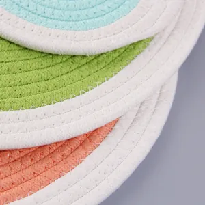 Close-up of spiral woven cotton coasters showing colorful texture and stitching details