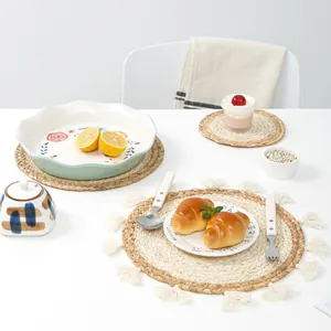 Handwoven natural corn husk placemats with tassel detail and ceramic tableware set