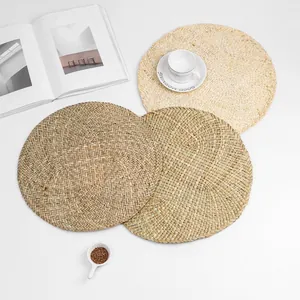 Set of three handcrafted round woven placemats in natural and dark wood tones