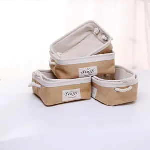 Three-piece set of jute storage baskets with white cotton rope handles and fabric lining