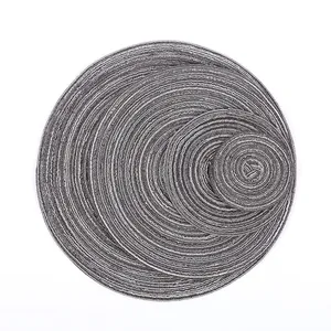 Detail of 4-piece grey and white woven round placemats showing texture and size variety