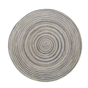 Macro detail of the concentric spiral weave and texture on a round linen placemat
