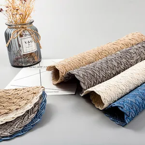 Close-up of woven ramie cotton placemats with delicate scalloped edges in various colors