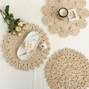 Detailed view of three handmade natural corn husk placemats with floral and wavy woven textures