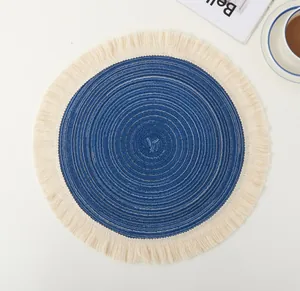 Close-up of blue ramie round placemat with white spiral weave and fringe trim edge