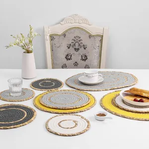 Top view of multicolored woven round placemats with spiral textures on a dining table