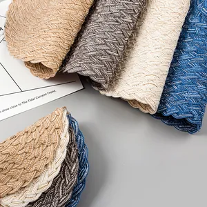 Detailed scalloped edges and woven texture of four multi-colored ramie cotton placemats