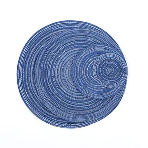 Detailed macro view of three layered round woven heat resistant placemats in navy and white