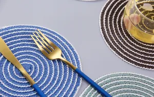 Detailed top view of spiral woven heat-resistant round placemats with soft dual-tone textures