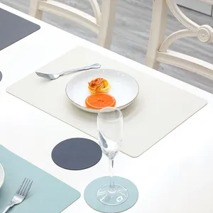 Close-up of modern Morandi silicone placemats and round coasters on a white dining table