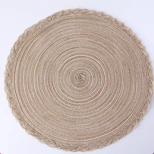 Detailed close-up of woven round placemat with spiral pattern and braided edge detail