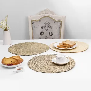 Detailed view of three circular handcrafted seagrass coasters on a white table