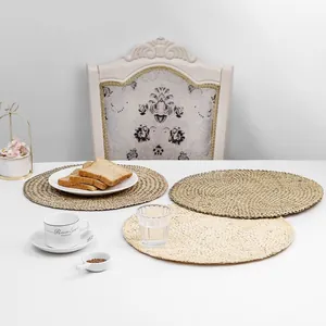 Detail of round woven straw placemats in natural colors with spiral textures for table decor