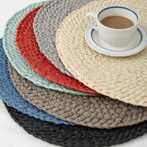 Close-up of colorful handmade woven fringe placemats for heat insulation on dining table