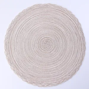 Detailed top view of a round woven heat-resistant placemat with cotton fiber spiral texture