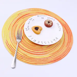 Detailed macro view of spiral woven textures in yellow and orange on round place mat