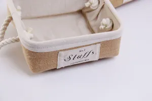 Detail of jute storage basket showing woven texture, cotton rope handle and fabric label