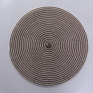 Top view detail of circular braided ramie placemat with spiral brown and white texture