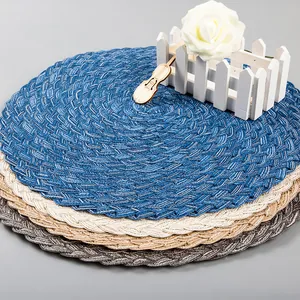 Detail of round woven ramie cotton heat-resistant placemats in multiple neutral colors