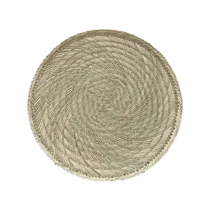 Handwoven round corn husk placemat with natural seagrass texture for dining table decor