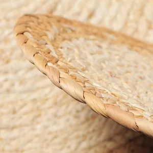 Macro shot of handcrafted corn husk placemat showing detailed woven edge and natural texture