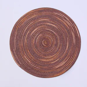 Detailed top view of a circular woven placemat with a spiral pattern in coffee brown