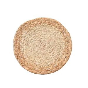 Handwoven round corn husk trivet with natural braided texture for heat protection