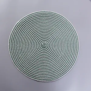 Detailed top view of round woven green and white spiral heat-resistant placemat