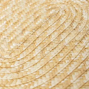 Macro detail of natural straw woven placemat showing intricate spiral texture and texture