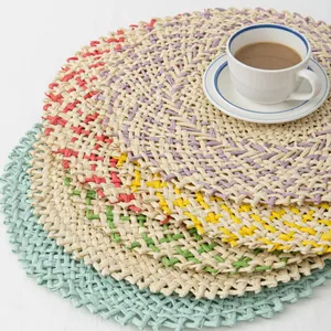 Close-up of handmade woven coasters with natural fiber textures and fringe details