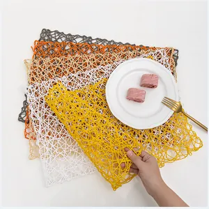 Handwoven rectangular paper rope placemats in multiple colors with hollow mesh design