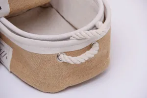 Detail of natural jute storage basket showing cotton rope handle and fabric lining