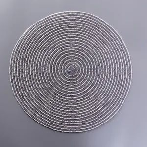 Detailed close-up of a circular woven placemat with gray and beige spiral pattern