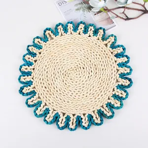 Detail of handwoven corn husk placemat with navy blue wavy edges and spiral texture