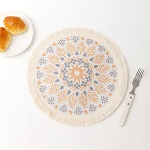 Bohemian mandala woven placemat with orange leaf patterns and decorative fringes