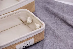 Macro shot of rectangular jute storage basket with thick cotton rope handles and fabric lining