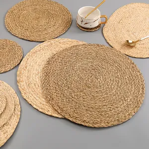 Detail of hand-woven natural seagrass place mats showing fine texture and varied sizes