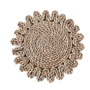 Handcrafted round corn husk placemat with floral petal edges in a natural woven style