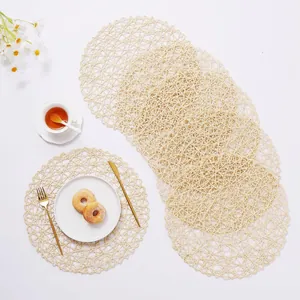 Detail of round woven fiber placemats featuring hollow mesh design for table heat insulation