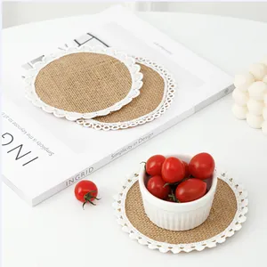 Macro shot of circular jute coasters with white lace fringe for home table decoration
