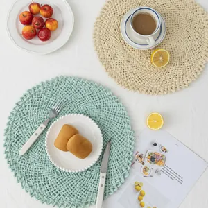 Handwoven round tassel placemats in mint green and beige for cozy home dining table decor
