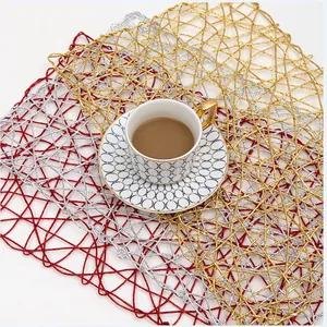 Handwoven rectangular paper rope placemats in gold, silver and red for home table decor