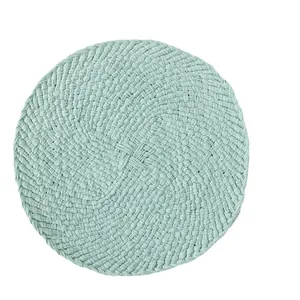 Handwoven circular mint green placemat with spiral texture for heat-resistant dining decor
