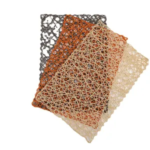 Handwoven rectangular paper rope placemats in grey, orange, and beige with hollow textures