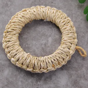 Close-up of natural straw placemat with thick weave texture and a hanging loop
