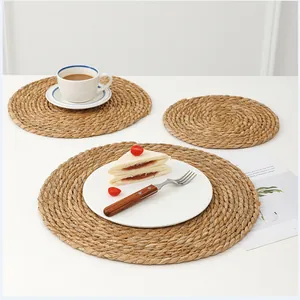 Macro detail of natural handmade round woven cattail placemats with spiral texture