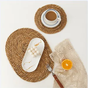 Handwoven round and oval cattail straw placemats set for rustic dining table decor