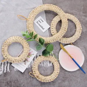 Detailed view of 4-piece woven straw heat-resistant placemats with hanging loops