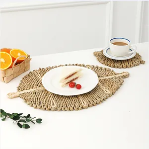 Handwoven leaf-shaped natural seagrass placemats and coasters for home table decor