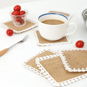 Close-up of woven jute coaster with lace trim and coffee cup for home decor